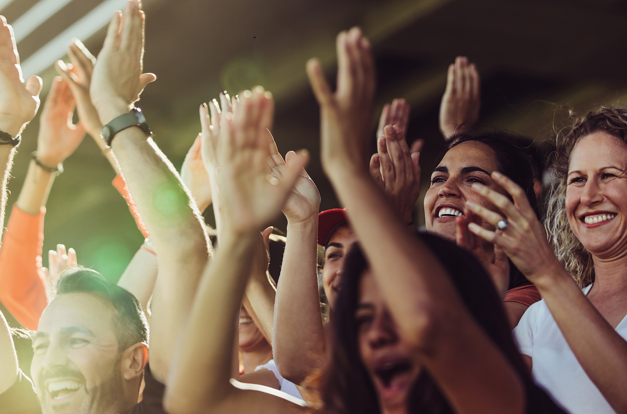 Football supporters clapping and chanting from stadium. Soccer team supporters cheering during a match at stadium.